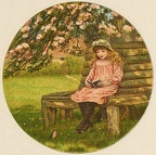 Little girl sitting and reading in the garden